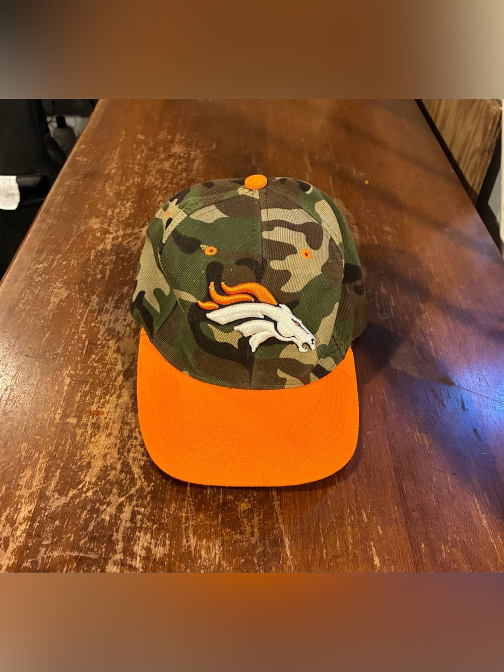 Denver Broncos Adult Camouflage Football Snap-Back Cap with Orange Brim. $6